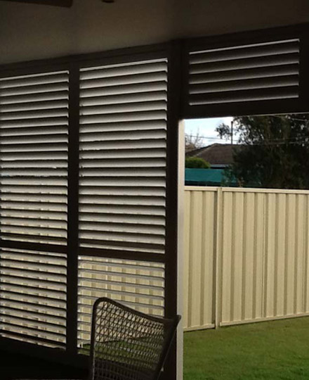 Dark PVC shutters fitted to outdoor patio windows