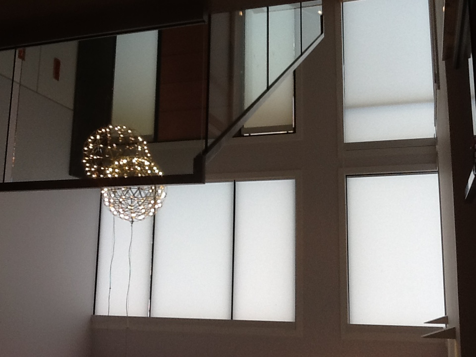 Window with roller blinds and chandelier