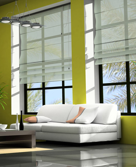 White Roman blinds in a modern living room with green walls and a white sofa