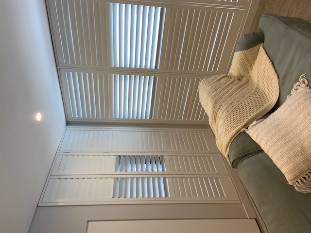 White timber shutters in a styled interior